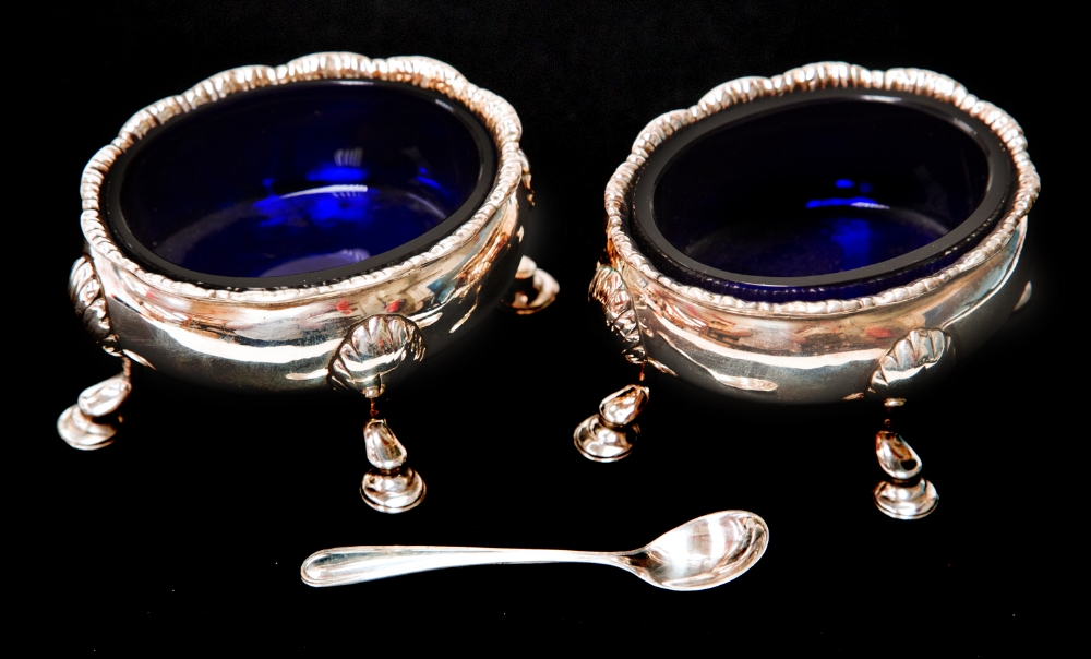 A pair of George III silver salt cellars with blue glass liners and sterling silver salts spoon,