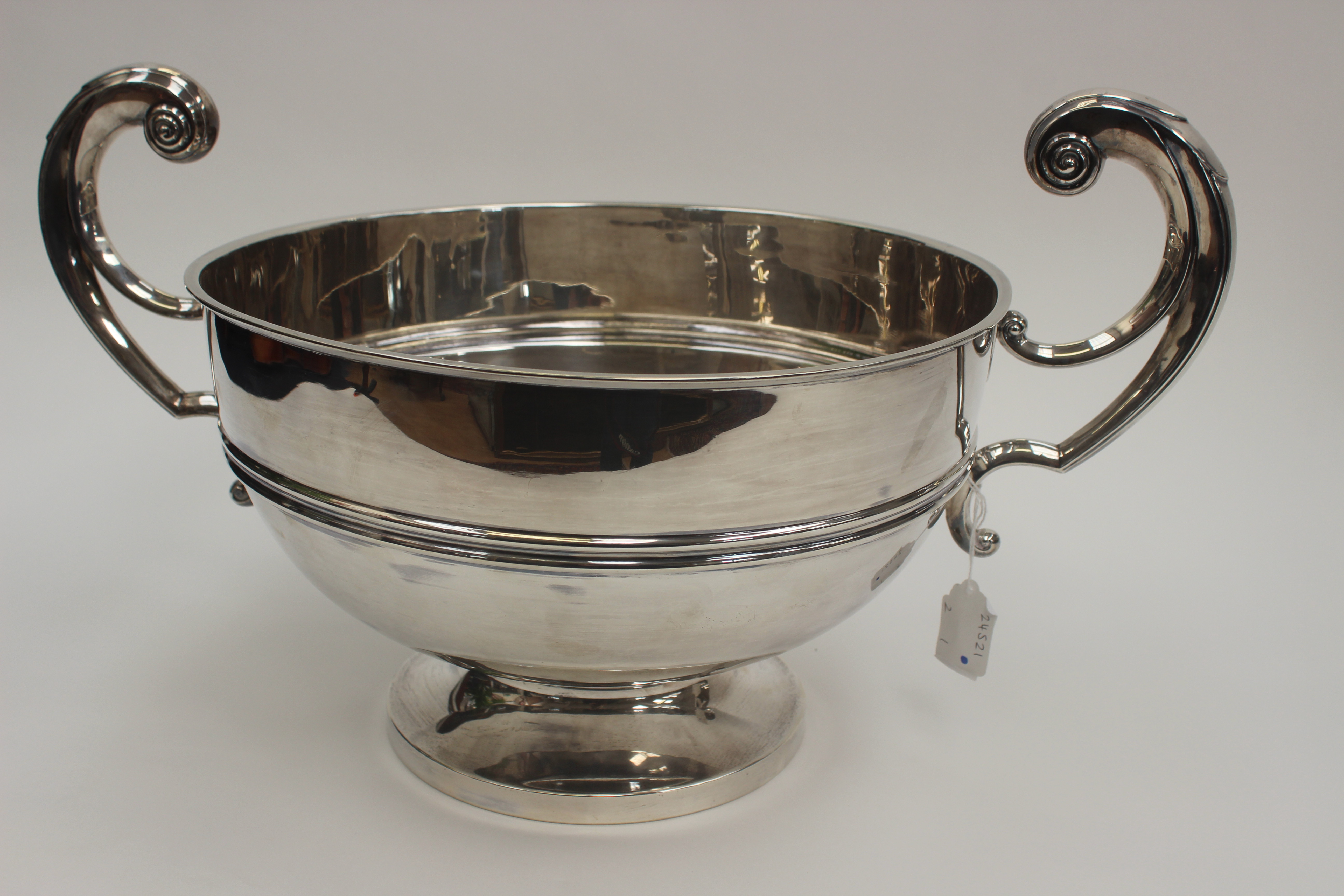 A George V silver twin-handled trophy bowl, S-scroll handles, spreading circular foot, 26cm high,