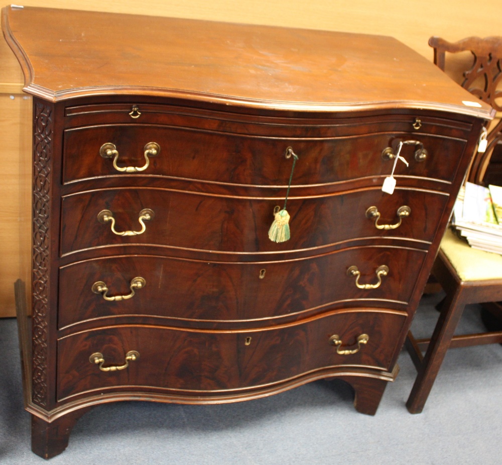 A late 19th century Chippendale style mahogany chest of drawers, of serpentine form, the brushing
