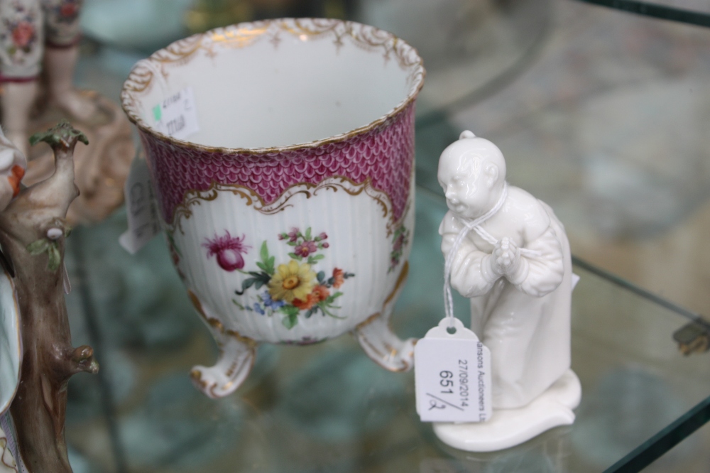 A Dresden three footed vase of fluted cup form, hand painted in the Rococo style with pink fish