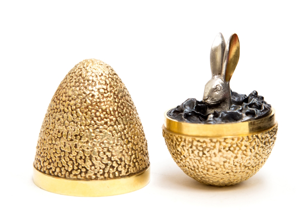 Stuart Devlin, a silver gilt surprise Easter egg, textured gravel exterior, the top opening to