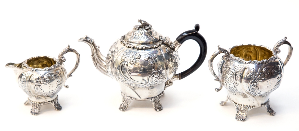 A Victorian silver bachelors tea set, of ogee form with heavy repousse type Rococo decoration and