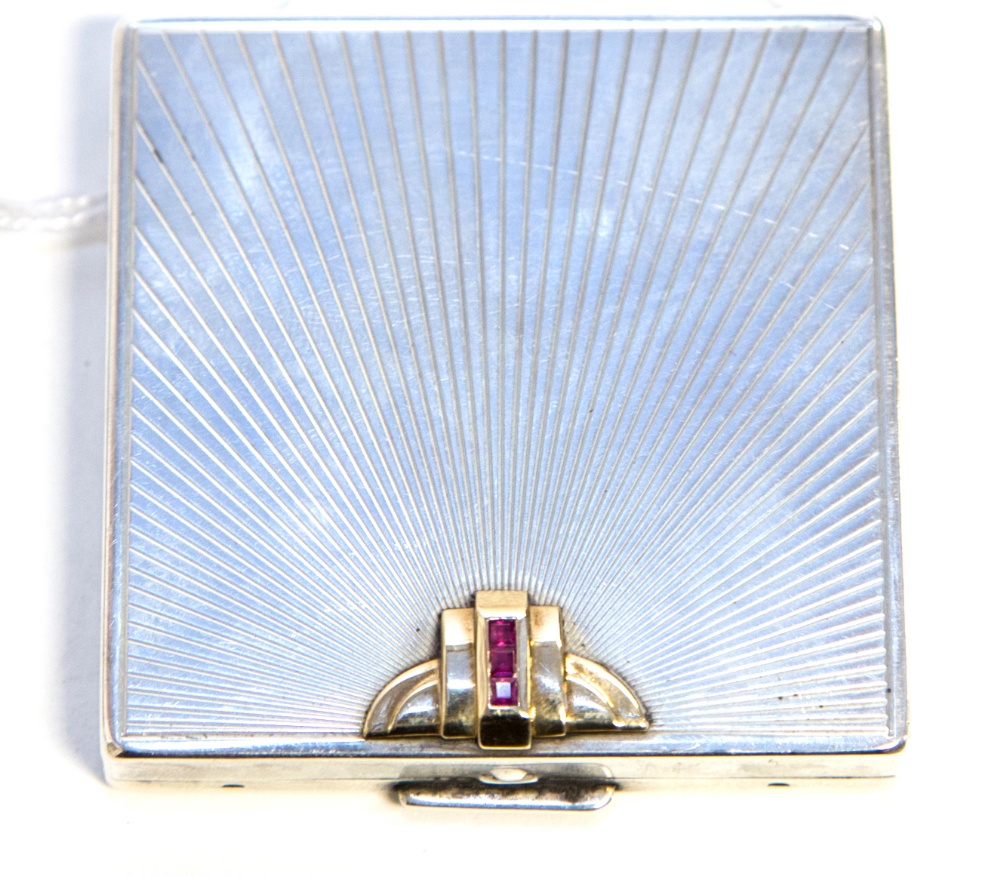 An Art Deco compact, by Black, Starr and Gorham, the hinged cover with sunburst design set with