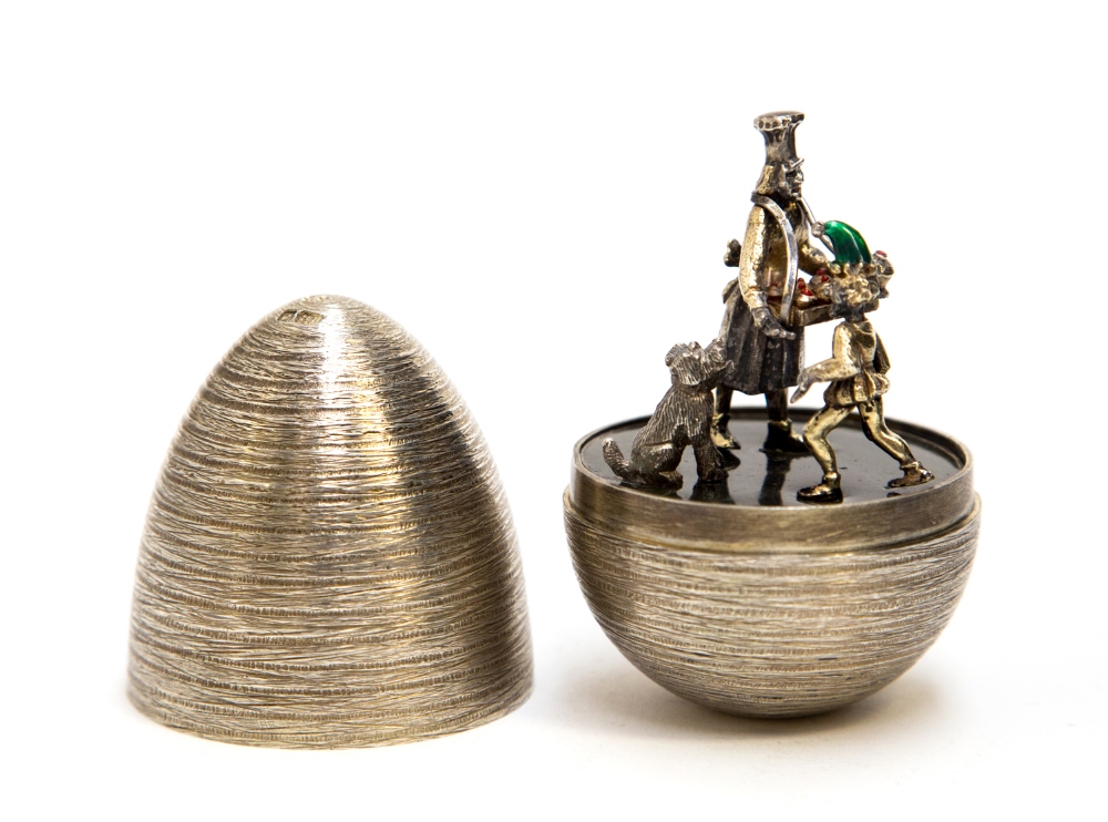 Stuart Devlin, a silver gilt surprise Easter egg, the concentric textured shell opening to reveal an