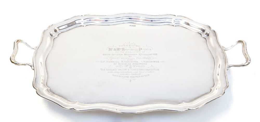 A George V twin handled silver tray, of wavy rectangular outline, bears presentation inscription,