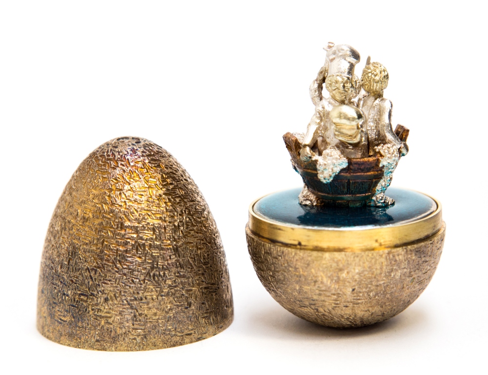 Stuart Devlin, a silver gilt surprise Easter egg, the incised hatch textured shell opening to reveal