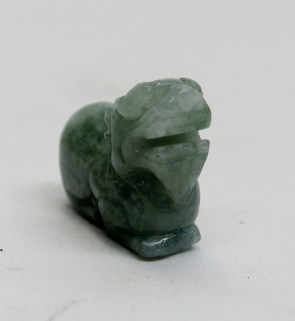 A Chinese jade pendant carved as a Dog of Foe, signed to the base, Chien Lung style, circa 19th