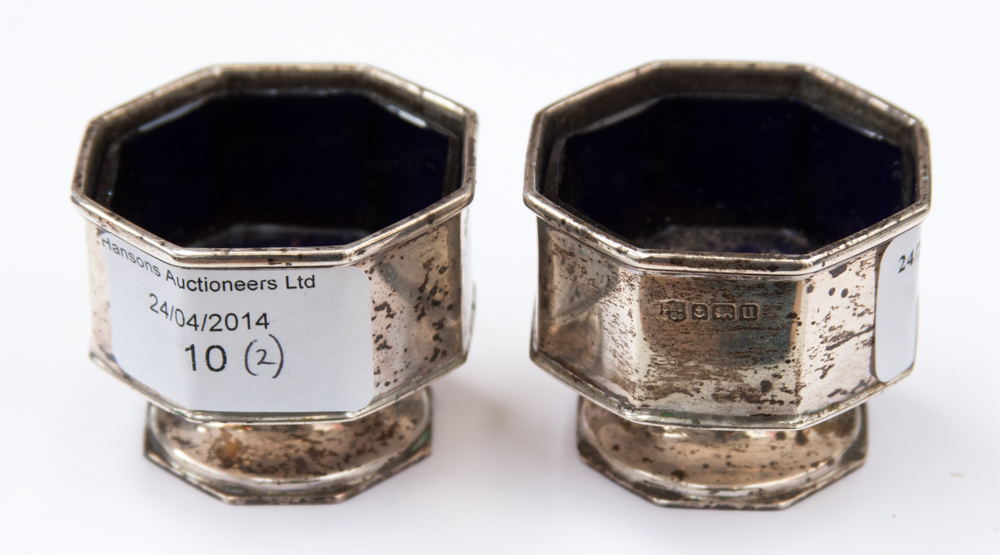 A pair of silver salt cellarettes in the form of Church Fonts, retaining original glass liners