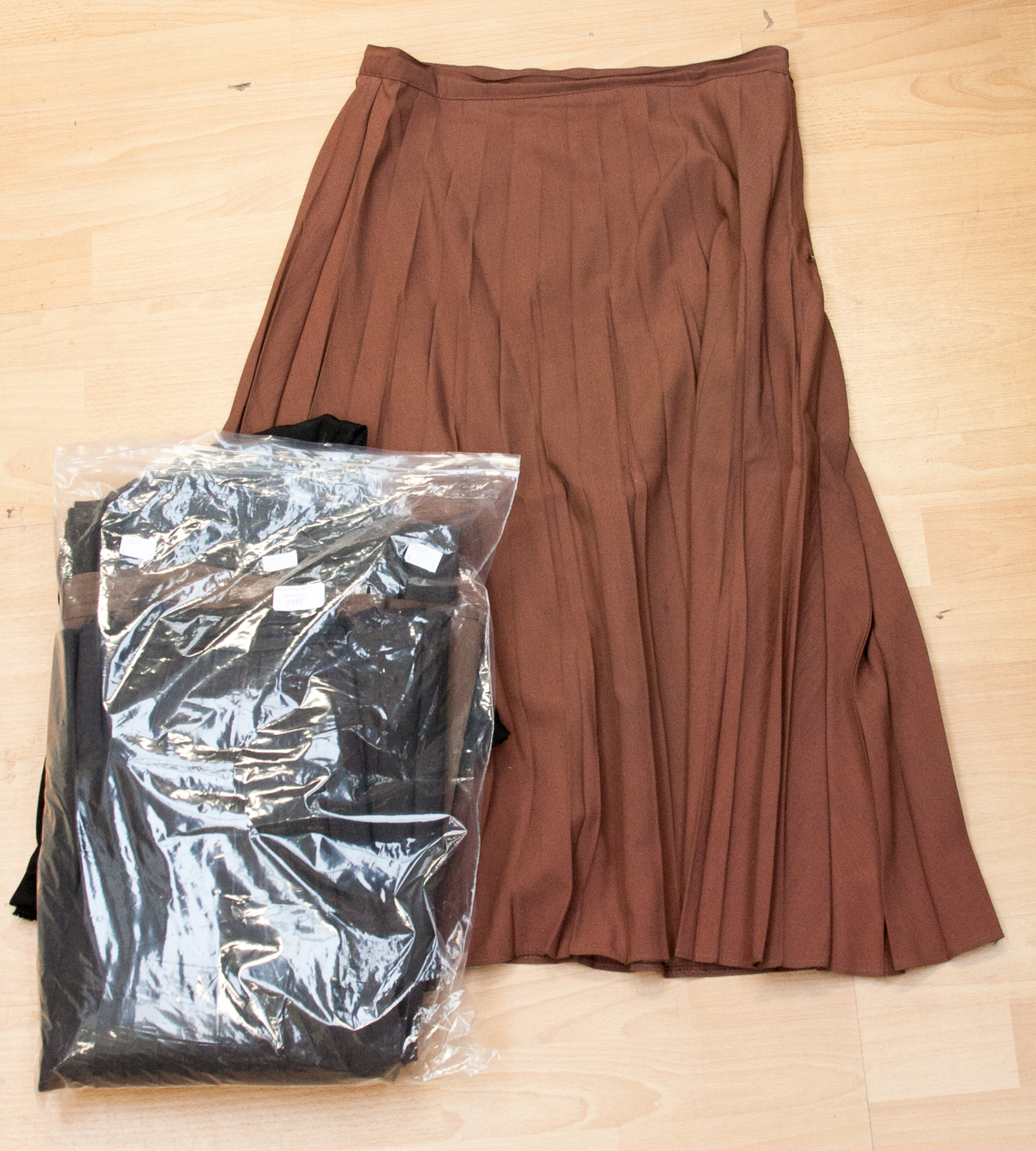 Seven 1950s accordion pleated skirts (3 brown, 2 grey, 1 black and 1 navy)