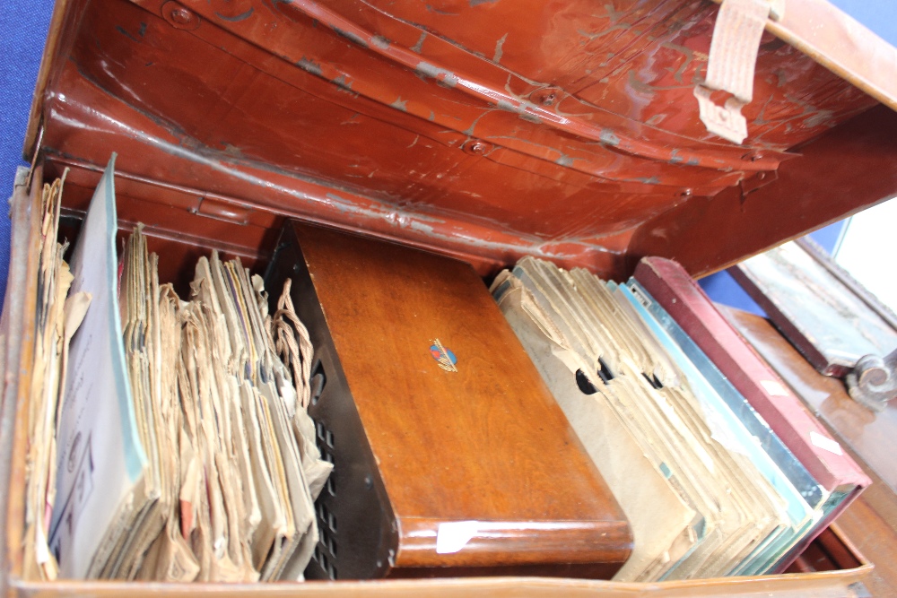 A large collection of 78s in a metal trunk, with a vintage Marconni speaker