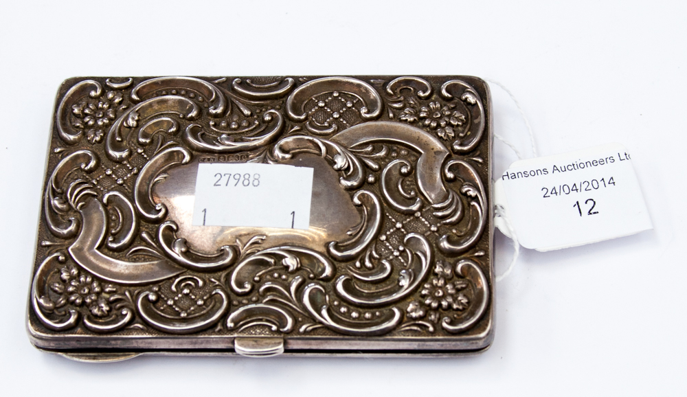 An Edwardian silver card case, the front and back decorated with Rococo style chase opening to