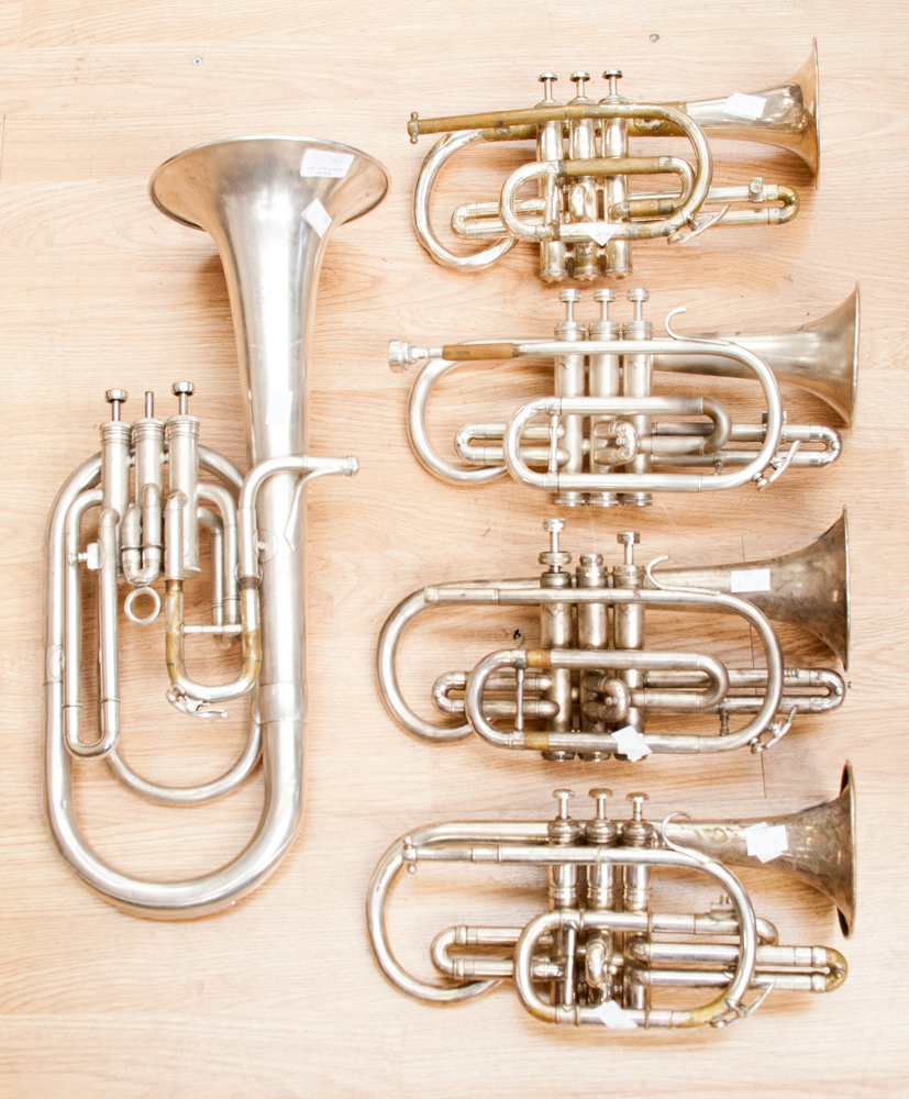 A Bossey & Hawkes '78' trumpet; a Besson and Co cornet; a Congress cornet; and a New Standard tennor