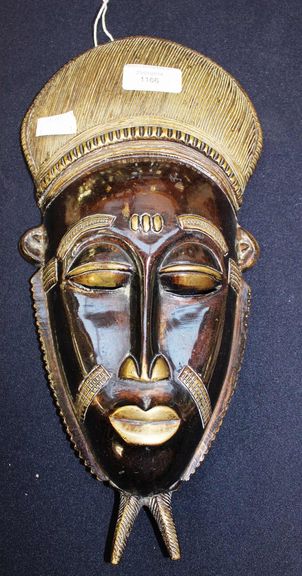 A French Colonial Baule Tribe (Ivory Coast) bronze mask, made in France circa 1910, 35cm high