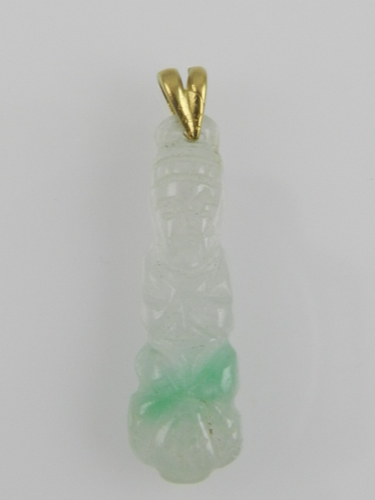 A pale green jade pendant in the form of a Buddha on a lotus flower, with yellow metal suspension