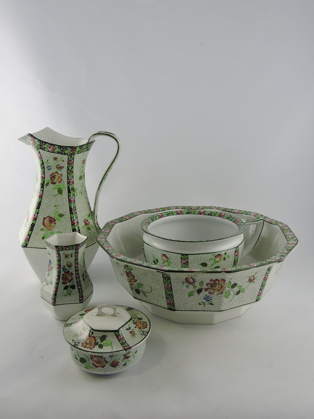 An early 20th century Hancock Coronaware five piece wash set, decorated with pink roses, jug H.