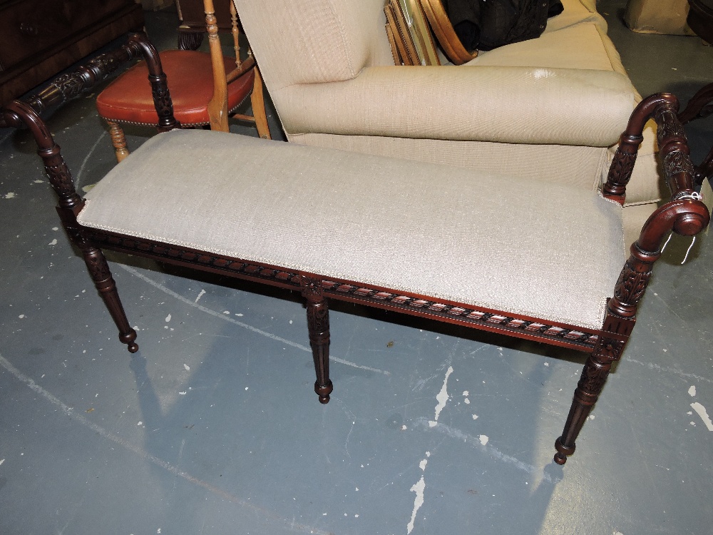 A Victorian style mahogany window seat, with natural fabric upholstery on turned tapered legs, W.
