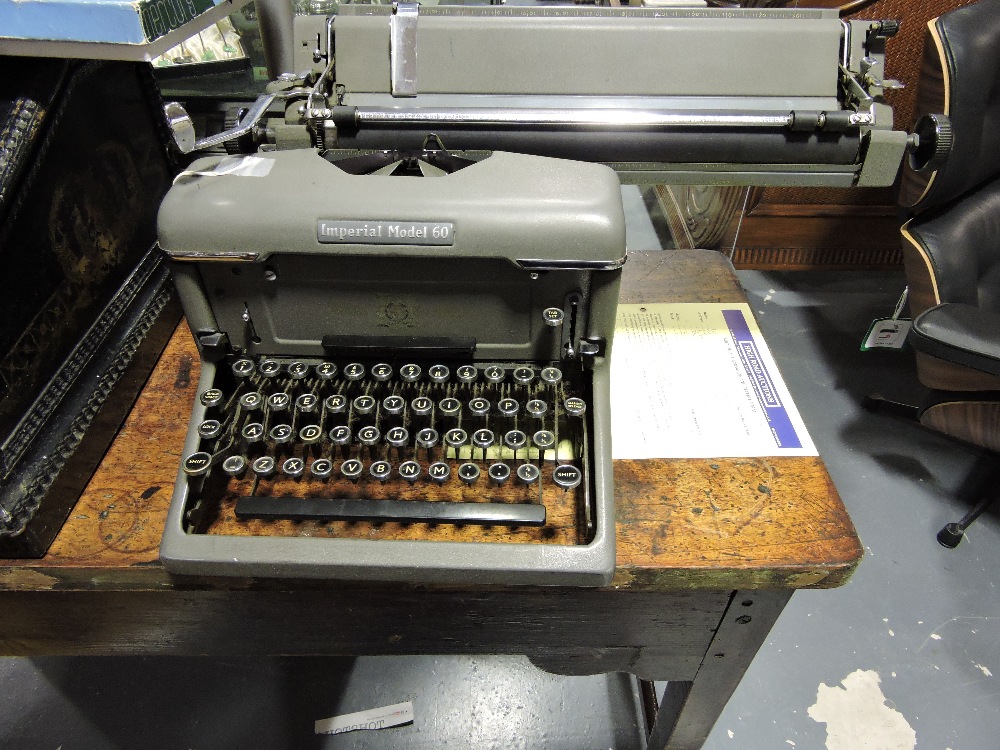 A vintage Imperial Model 60 typewriter with grey finish, together with original cover and a large