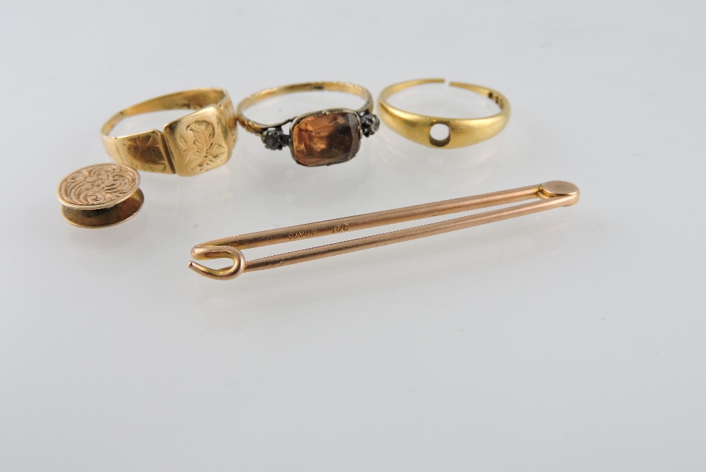 Two 18ct gold rings, large 9ct safety pin, dress ring set with pink stone and a circular stud,