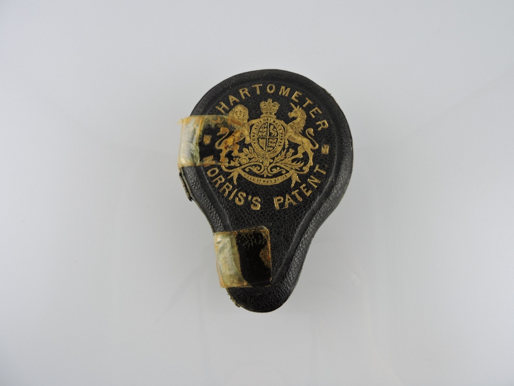 A Morris's pocket chartometer in patent leather case gilt embossed with Royal Coat of Arms,