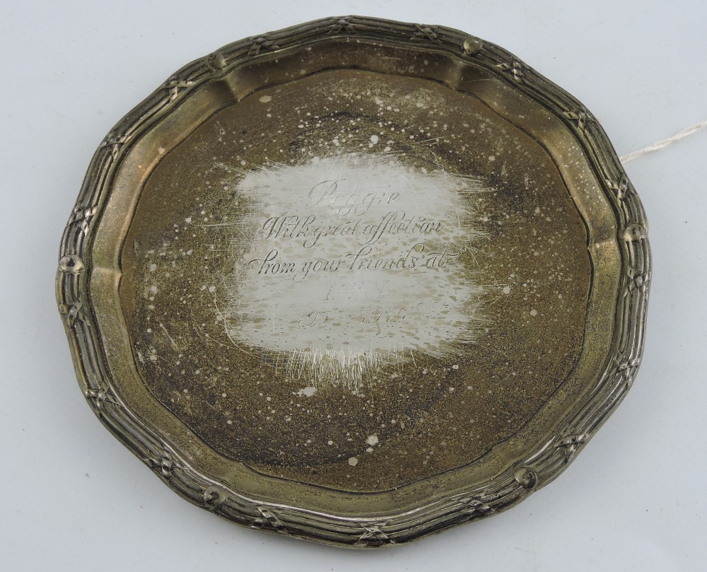 A silver waiter, Sheffield 1949, with a shaped reeded edge and a presentation inscription