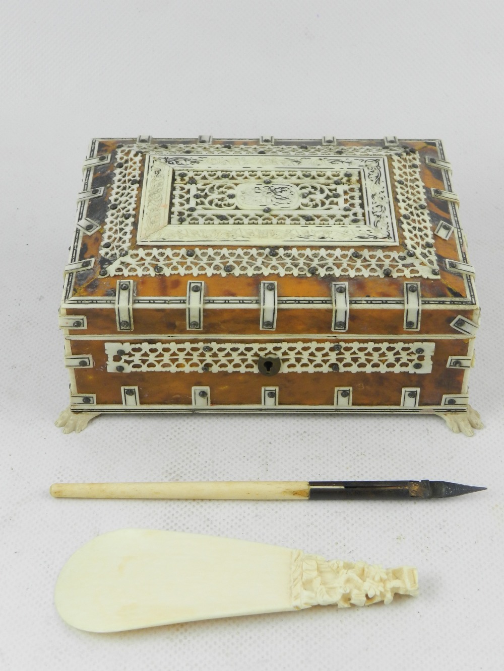 An Indian bone mounted tortoise shell inlaid trinket box, raised on four paw feet, together with a