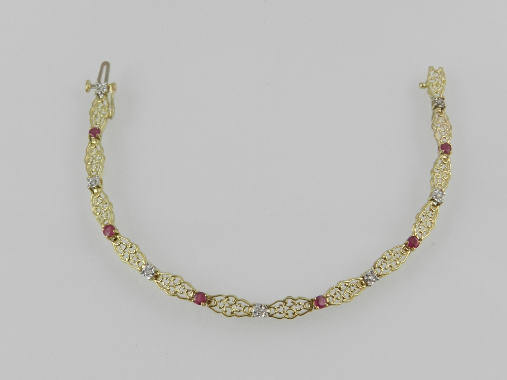 An unusual yellow metal filigree articulated line bracelet, set with diamonds and rubies, the