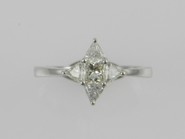 An 18ct white gold diamond set dress ring, set with ascher and trillion cut stones of