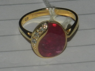 A ruby and diamond set dress ring, the shank stamped 585.