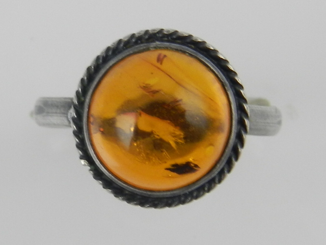A silver cabouchon amber dress ring.