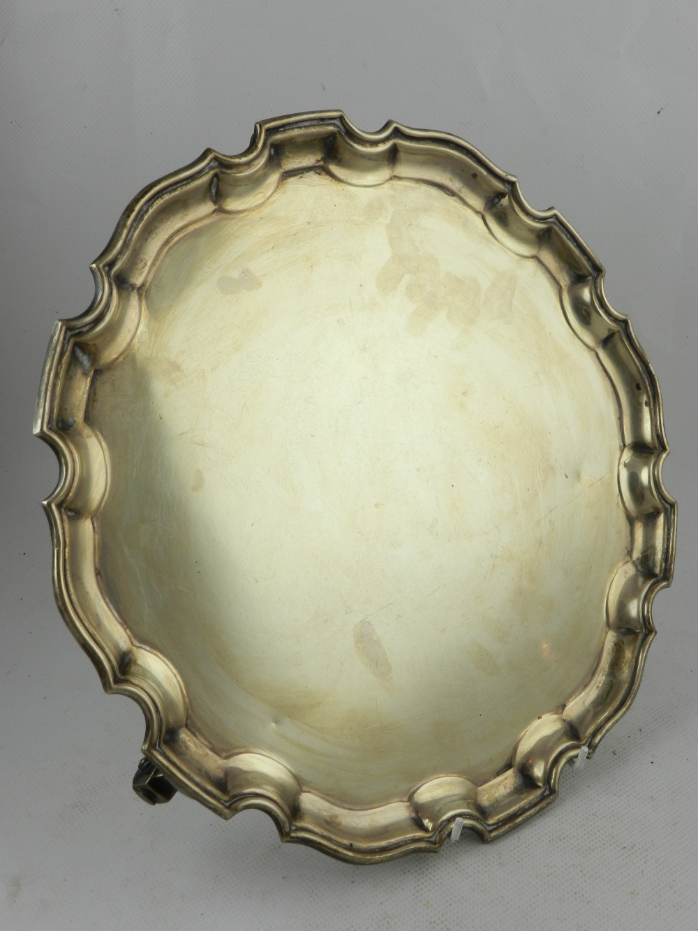 A George II style silver salver, having waved edge and scroll feet, hallmarked London, 1965,