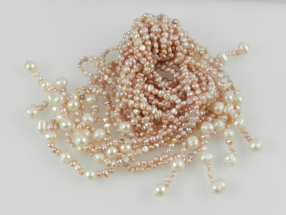 A pink and white pearl multi stranded necklace.