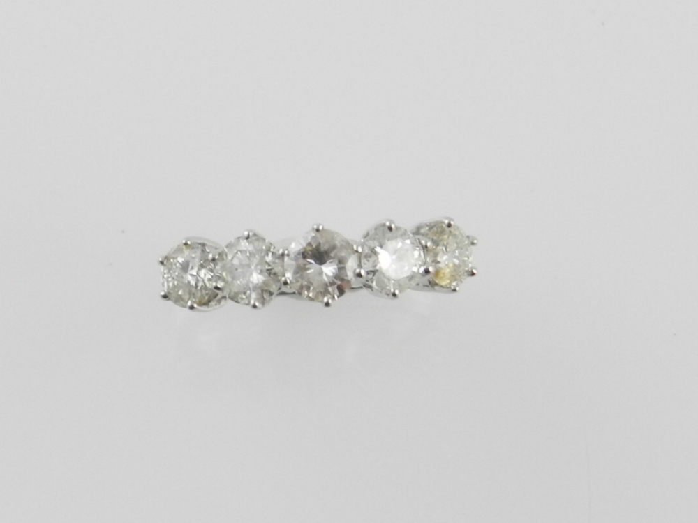 An 18 carat white gold five stone diamond ring, the graduated brilliant cut stones of approx. 1.63