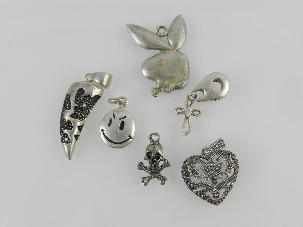 A small collection of six various white metal pendants.