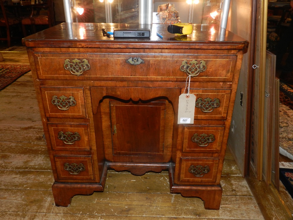 A Queen Anne style walnut knee-hole desk, cross-banded and boxwood line inlaid, fitted a frieze