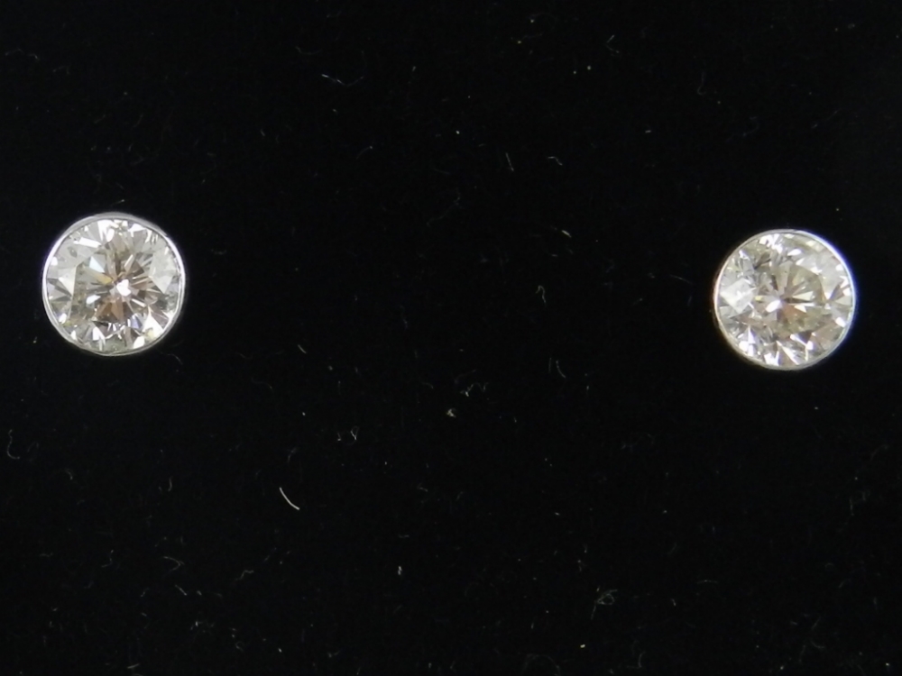 A pair of 18ct white gold diamond ear studs, with open work mounts, set with brilliant cut stones of