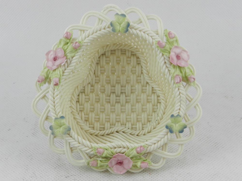 Belleek, Ireland. A hard paste porcelain basket, decorated with shamrocks and pink pansies,