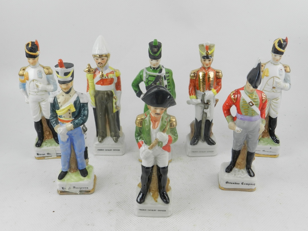 A collection of eight porcelain figures of soldiers from various regiments, raised on pedestal