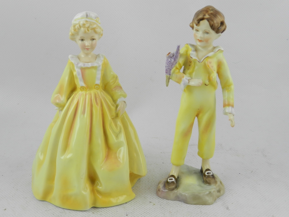 A Royal Worcester porcelain figurine of a young boy, 'The Parakeet', together with one other