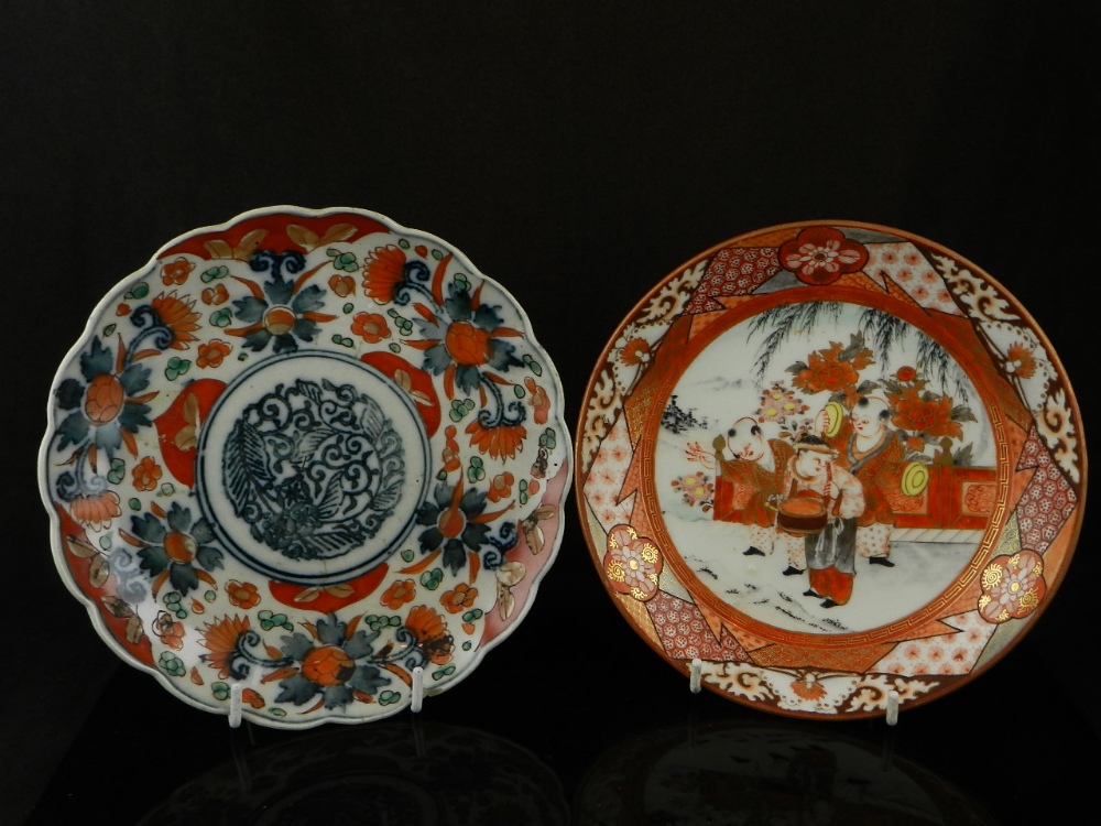 A Kutani porcelain plate centred with three figures, decorated border, bearing three character marks