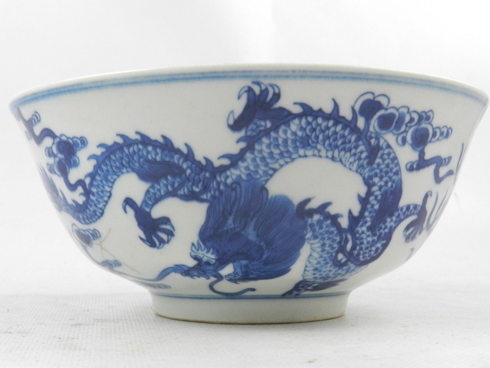 A Chinese blue and white porcelain bowl, raised on rim foot, decorated with studies of dragons - Image 3 of 4