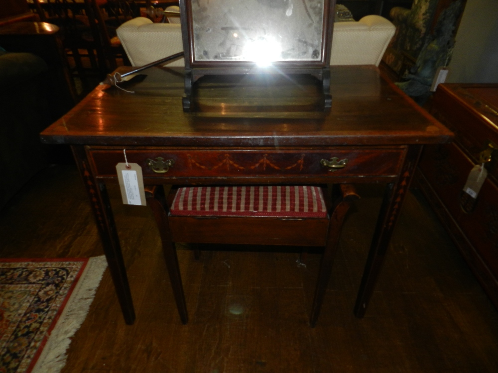 A George III mahogany and satinwood cross-banded writing table, decorated with garlands of bell