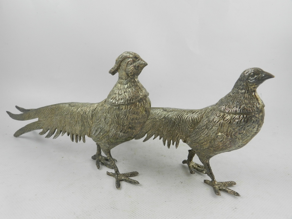 A pair of 20th century silver plated studies of a male and female pheasant. L.28cm