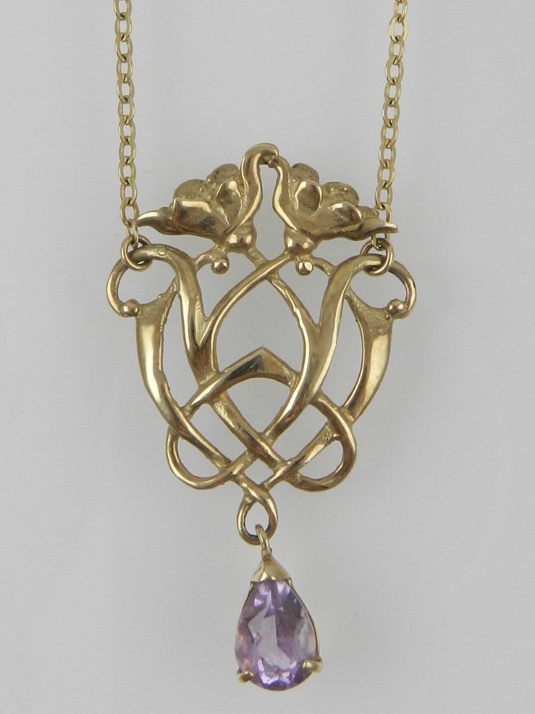 An Art Nouveau style yellow metal and amethyst drop pendant, the clasp stamped 375.