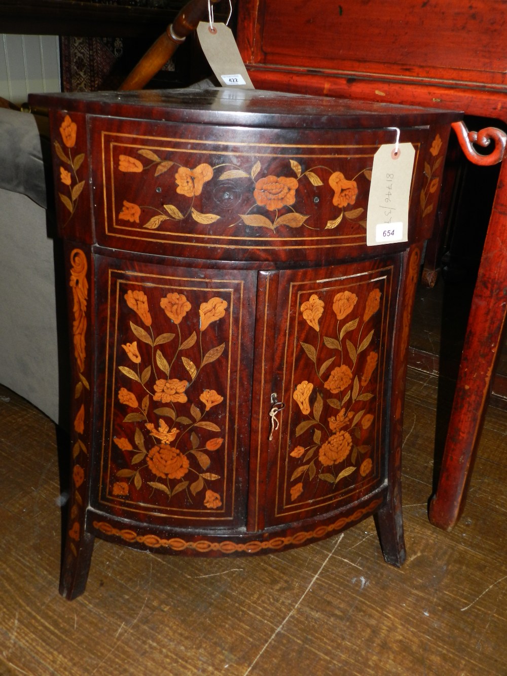 An early 19th century Dutch walnut and floral marquetry standing corner cupboard, fitted swing-out