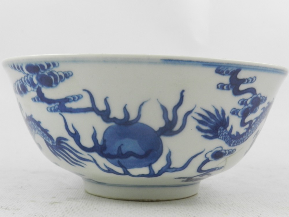 A Chinese blue and white porcelain bowl, raised on rim foot, decorated with studies of dragons - Image 2 of 4