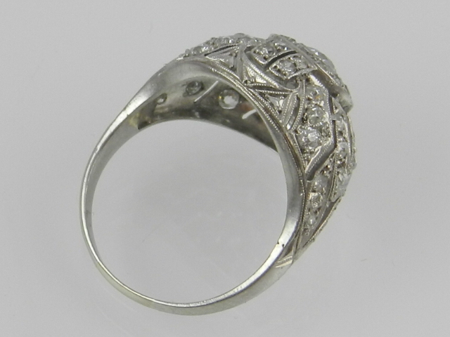 An unusual white metal and diamond dress ring, set central stone of approx. 0.3 carats - Image 2 of 2