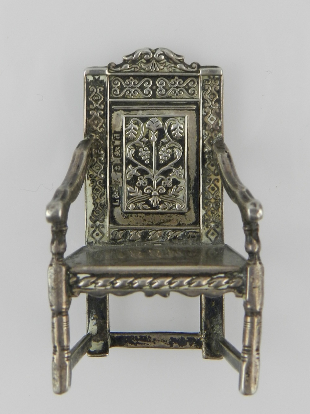 An unusual Edwardian miniature silver wainscot elbow chair, in the 17th century style, hallmarked