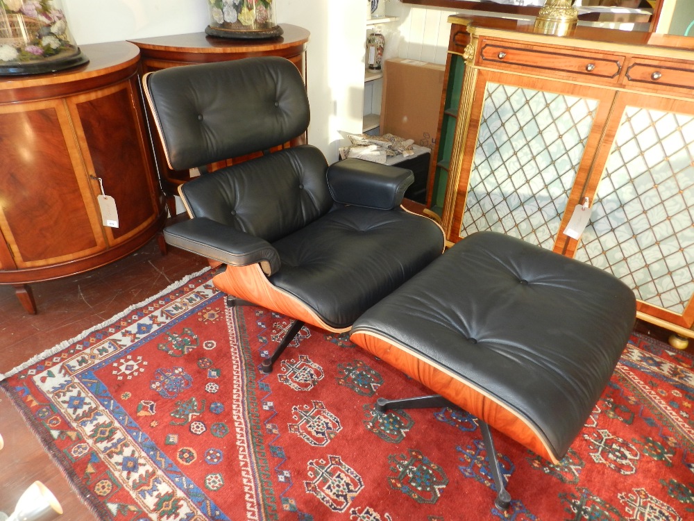 After Charles and Ray Eames. A rosewood and black leather upholstered swivel lounge chair (670),