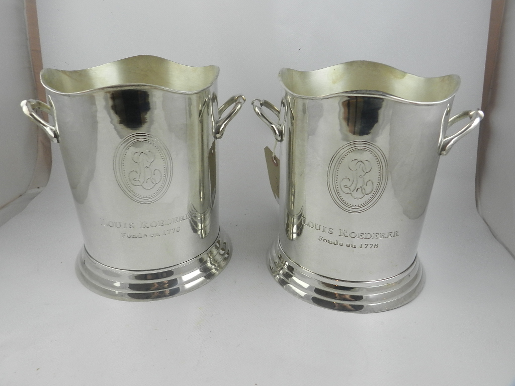 A pair of silver plated twin handled ice buckets raised on step circular bases. H.23.5cm