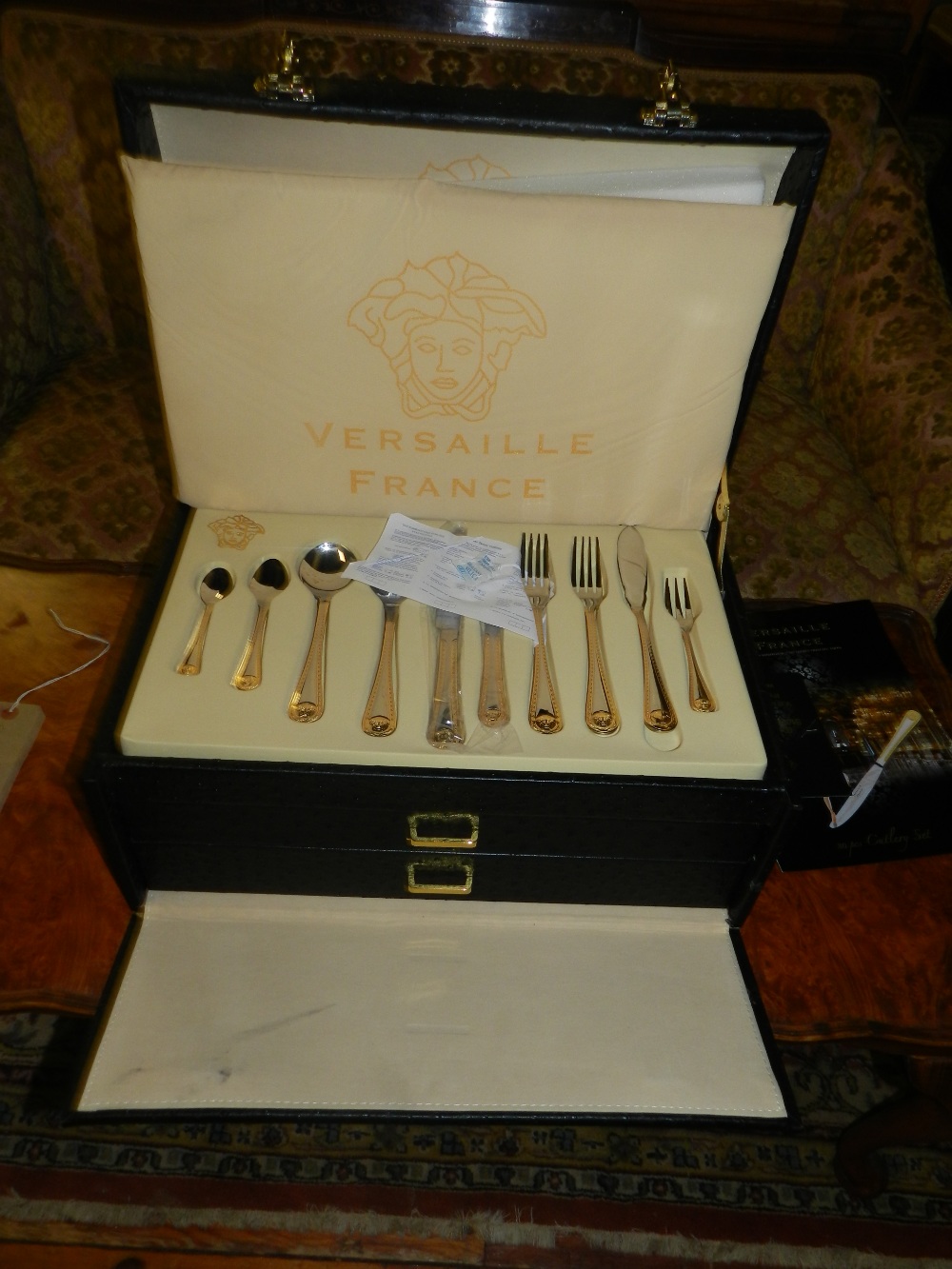 Versaille, France. 80 piece gilt metal mounted stainless steel canteen of cutlery, set in a domed